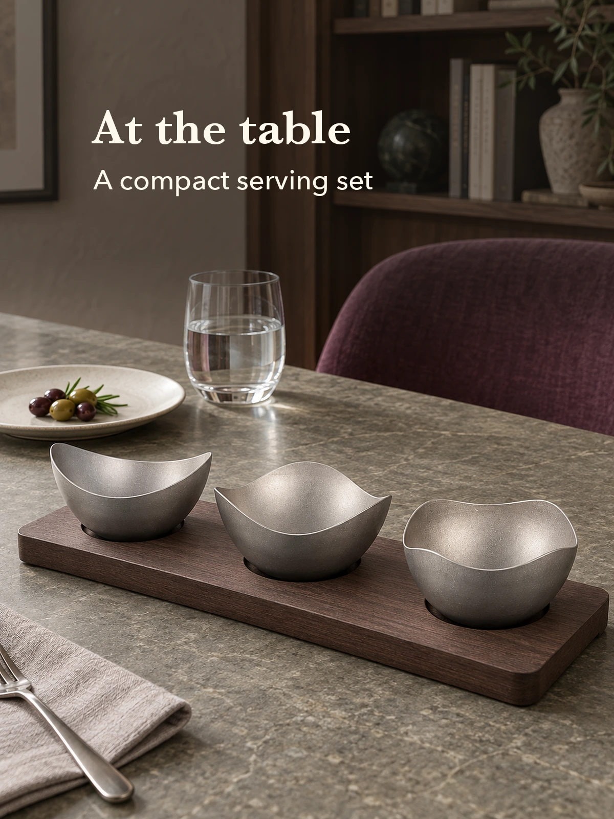 Serving set beside a plate and drinking glass for scale